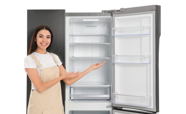 Young,Woman,Near,Empty,Refrigerator,On,White,Background